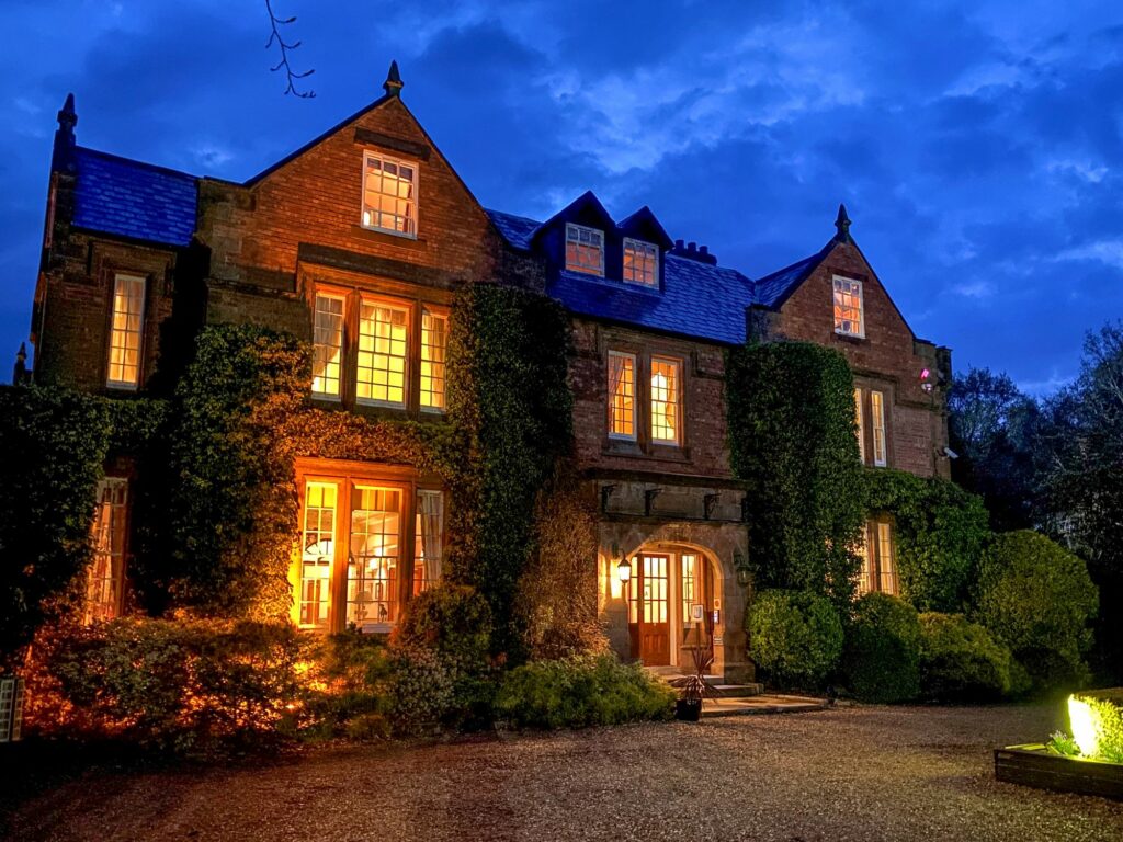 Nunsmere Hall lit up at night