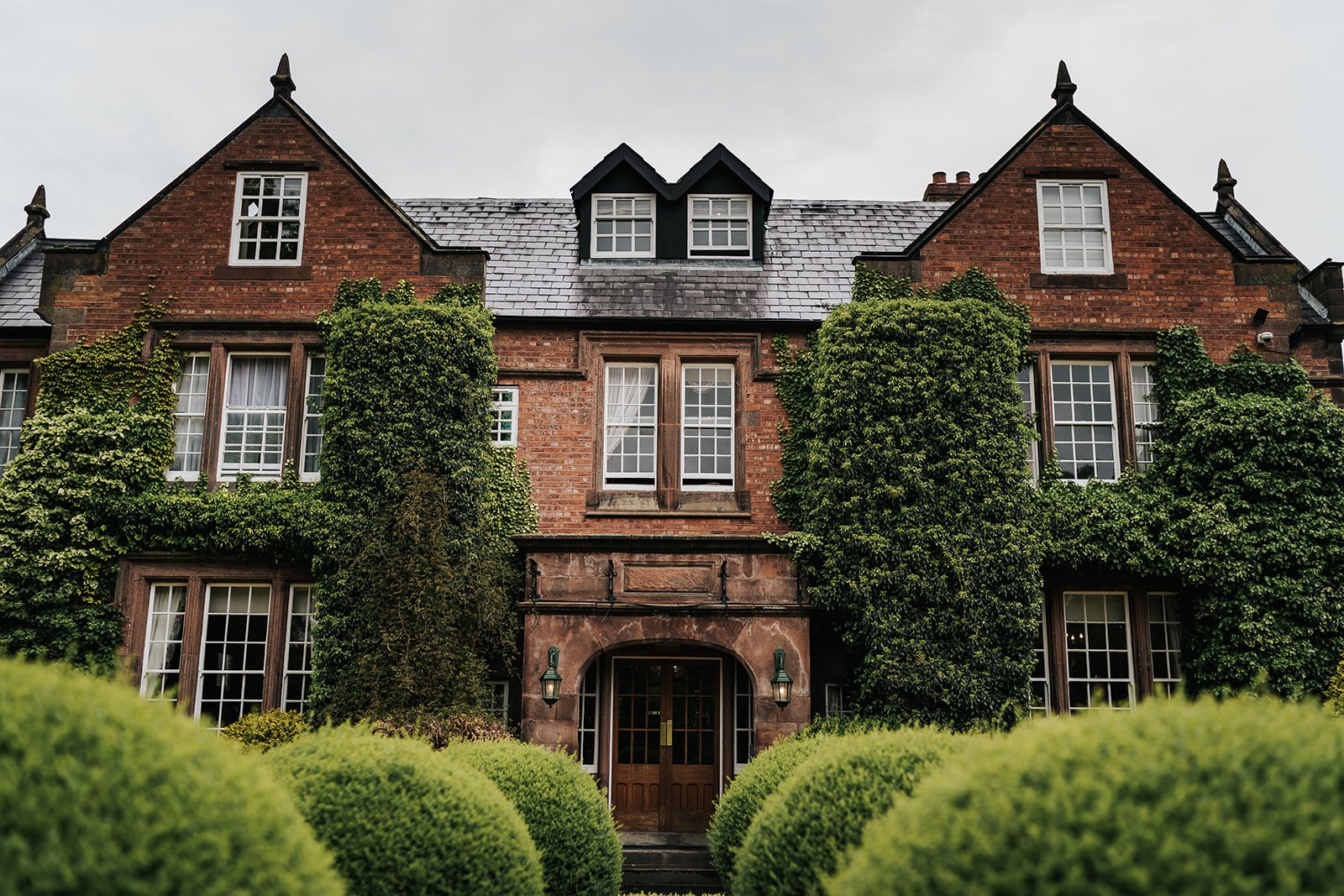 Nunsmere Hall exterior shot with hedges