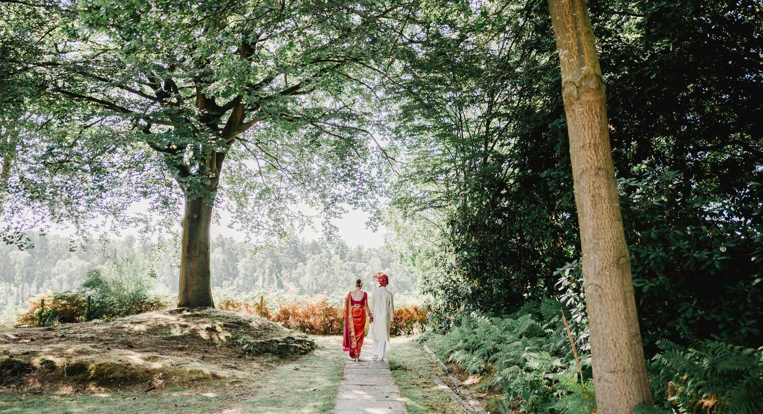 Couple walking together in the gardens at Nunsmere Hall